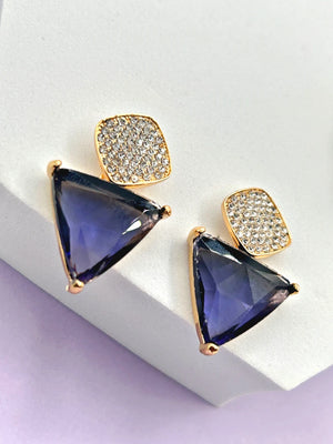 Side view of the Aria purple triangle stud and dangling CZ teardrop earrings on a model's ear, highlighting the gold setting