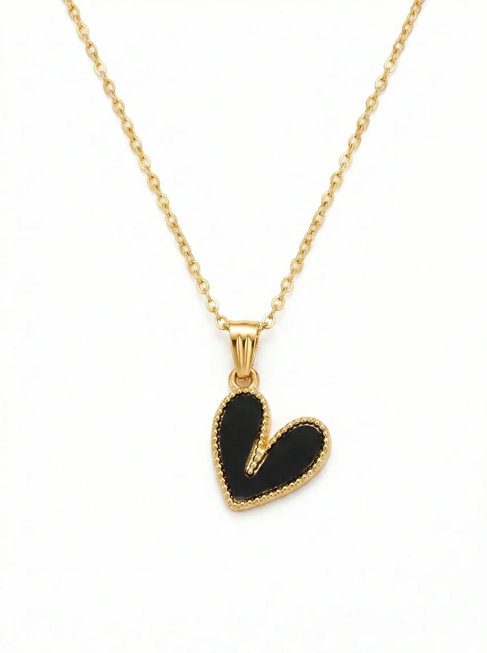 Gold necklace with a black heart pendant on a white background