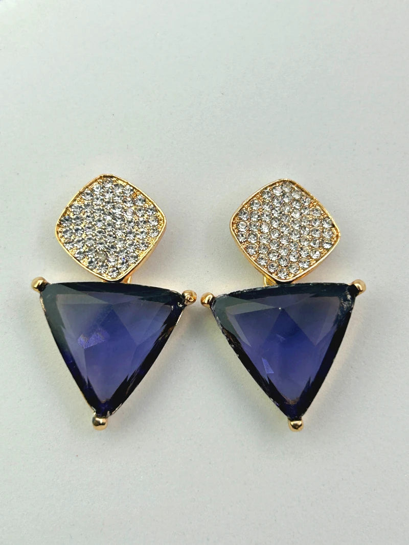 Close-up detail shot of the faceted purple triangle stone and brilliant teardrop CZ of the Aria dangle earrings.
